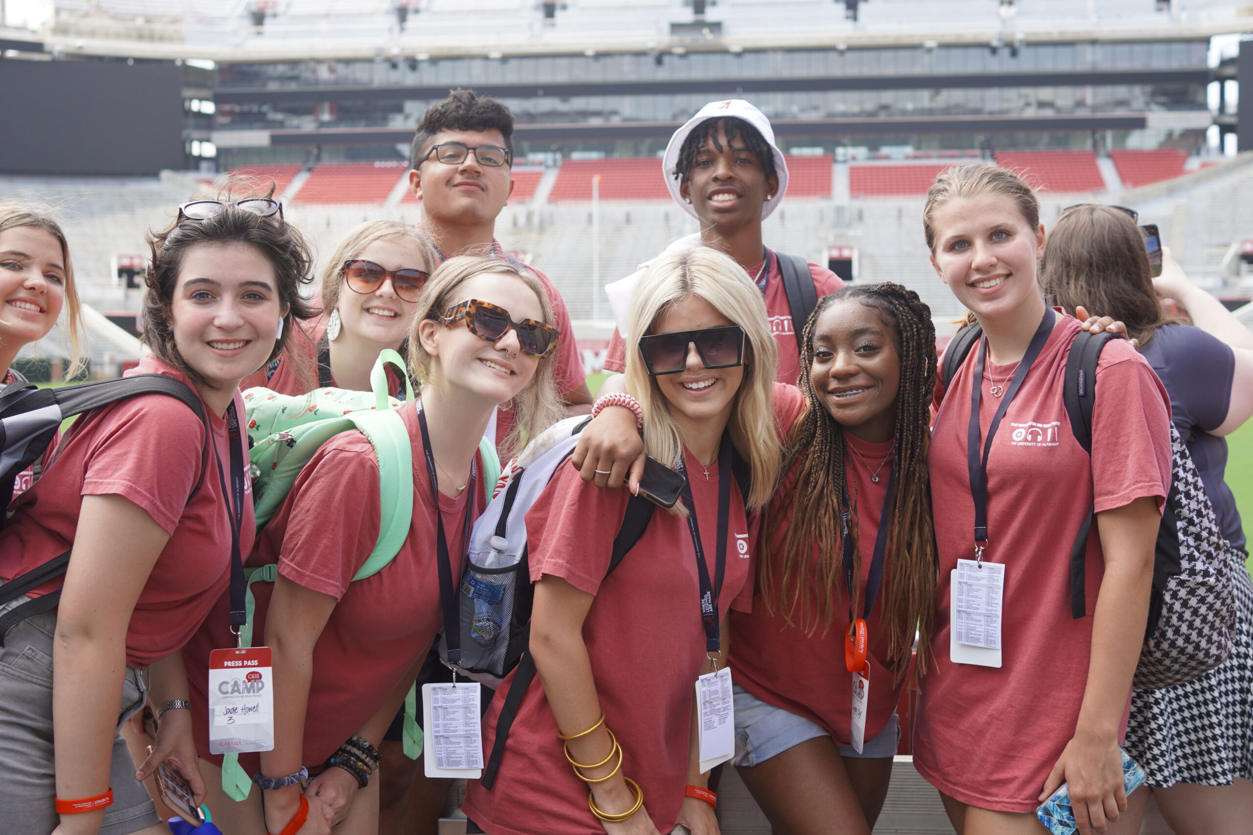 A group of CAMP participants smiling for a photo in Bryant Denny Stadium