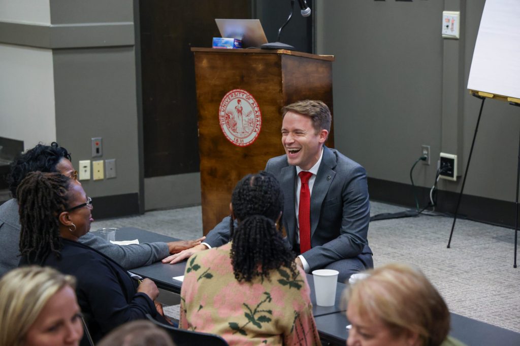 Adam Brooks holds hands with a participant during the 2024 FOSAS Conference