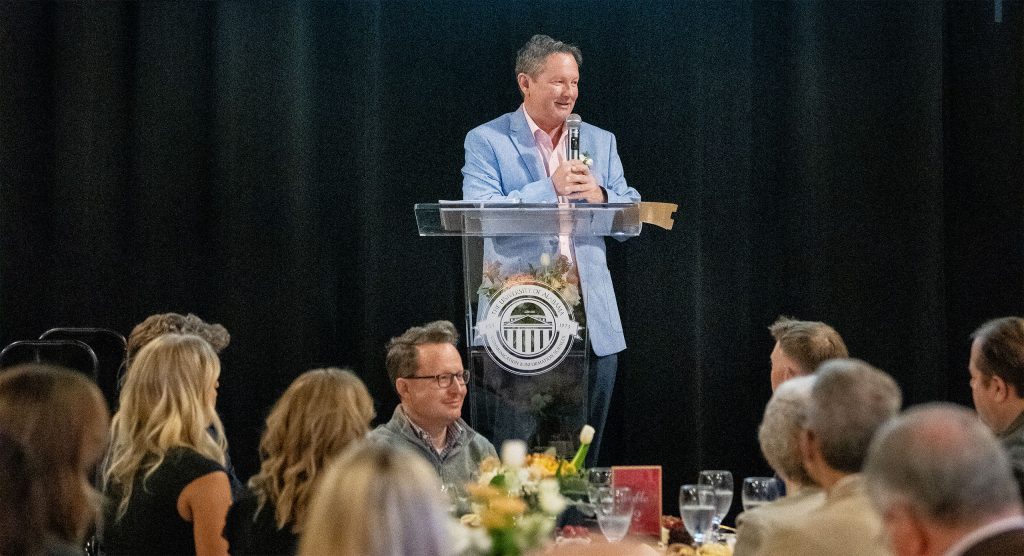 Lars Anderson stands at a podium accepting the Cason Award in April 2025